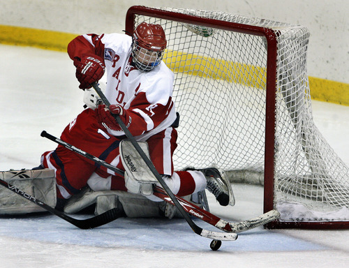 Scott Sommerdorf  |  The Salt Lake Tribune             
Regis Jesuit forward Marshall Conrad gets tangled up with Waterloo goalie Chance Kremer as he battles to push the puck over the goal line for an apparent goal during third period play. Officials later waved off the goal  because Conrad was in the goal crease. The Regis Jesuit (Colo) Raiders won the 2012 USA High School Hockey Championship with a 4-3 win over the Waterloo (Iowa) Warriors, Sunday, March 25, 2012.