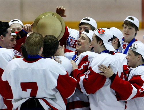 Scott Sommerdorf  |  The Salt Lake Tribune             
The Regis Jesuit (Colo) Raiders mob around the championship trophy after they won the 2012 USA High School Hockey Championship with a 4-3 win over the Waterloo (Iowa) Warriors, Sunday, March 25, 2012.