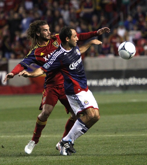 Rick Egan  | The Salt Lake Tribune 

Real Salt Lake's Kyle Beckerman (5)  goes for the ball, along with Nick LaBrocca, Chivas USA, in MLS soccer action in Sandy, Saturday, March 24, 2012.