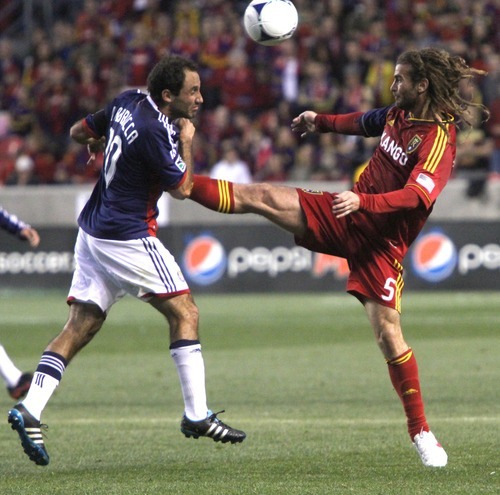 Rick Egan  | The Salt Lake Tribune 

Real Salt Lake's Kyle Beckerman (5)  gets his foot on the ball, Nick LaBrocca Chivas USA, defends, in MLS soccer action in Sandy, Saturday, March 24, 2012.