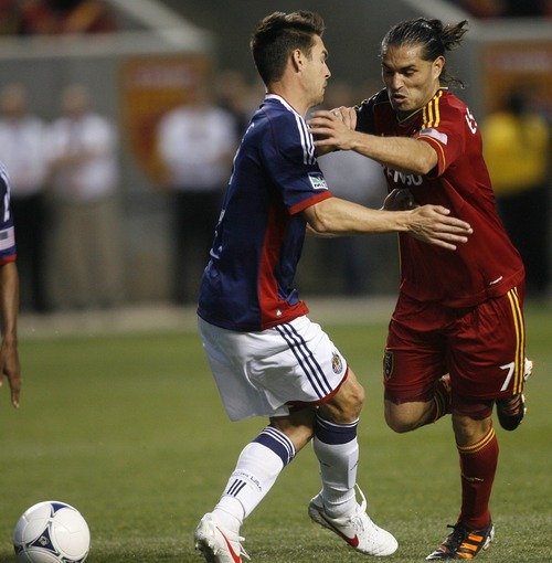 Rick Egan  | The Salt Lake Tribune 

Real Salt Lake's Fabian Espindola (7)  troes to get by Chiva's USA's  Heath Pearce, in MLS soccer action in Sandy, Saturday, March 24, 2012.