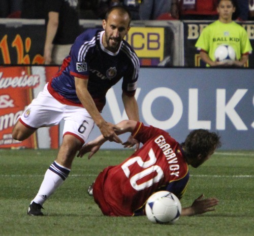 Rick Egan  | The Salt Lake Tribune 

Real Salt Lake's Nat Borchers (6) is knocked down by  Peter Vagenas, Chivas USA, in MLS soccer action in Sandy, Saturday, March 24, 2012.