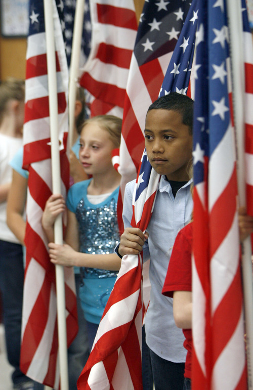 Francisco Kjolseth  |  The Salt Lake Tribune
Whitney Mcelreath, left, and Lopi Po'oi, 9, Third-graders at Falcon Ridge Elementary get ready for a flag presentation where Governor Gary R. Herbert signed into law three education-related bills at the school in West Jordan on Tuesday, March 27, 2012.