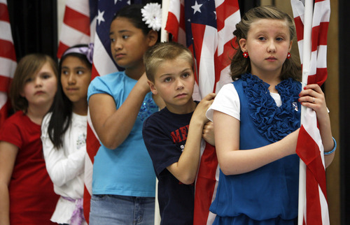 Francisco Kjolseth  |  The Salt Lake Tribune
Third-graders at Falcon Ridge Elementary Emily Hewitt, 8, Madeline Leano, 9, Pisila Fangupo, 9, Jack Anderson, 8, and Eve Benedict, 8, from left, get ready for a flag presentation where Governor Gary R. Herbert signed into law three education-related bills at at the school in West Jordan on Tuesday, March 27, 2012.