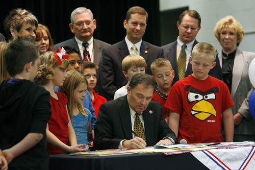 Francisco Kjolseth  |  The Salt Lake Tribune
Gov. Gary Herbert, surrounded by state representatives and third-graders from Falcon Ridge Elementary in West Jordan signs three education-related bills following a flag ceremony assembly on Tuesday, March 27, 2012.