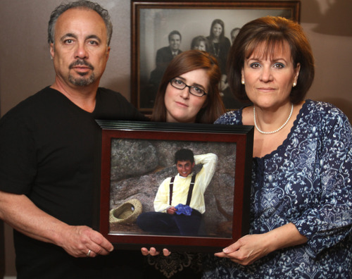 Rick Egan  | The Salt Lake Tribune 

Steve Randall, left, Halee Randall and Jolene Randall, right, on Monday, March 26, 2012, hold a picture of their son and brother, Jacob, taken last summer on a pioneer trek in Wyoming. They were shocked to learn Jacob had been experimenting with heroin after he died of an accidental overdose in February.