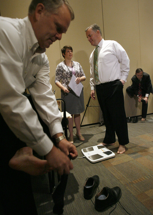 Francisco Kjolseth  |  The Salt Lake Tribune
Doing their weigh-in, Scott Osborne, Mayor of South Jordan, Peter Corroon, Mayor of Salt Lake County and Darrell Smith, Mayor of Draper, from left, are checked by exercise therapist Meagan Kline. Eight mayors from cities in the Salt Lake valley, two city coucil men, a city attorney and a city manager, for a total of twelve are participating in the 100-day 'My Heart Challenge' sponsored by Intermountain Medical Center Heart Institute as the event kicks off on Thursday, March 29, 2012. The twelve participants will work to improve their heart health through changes in their eating and exercise habits.