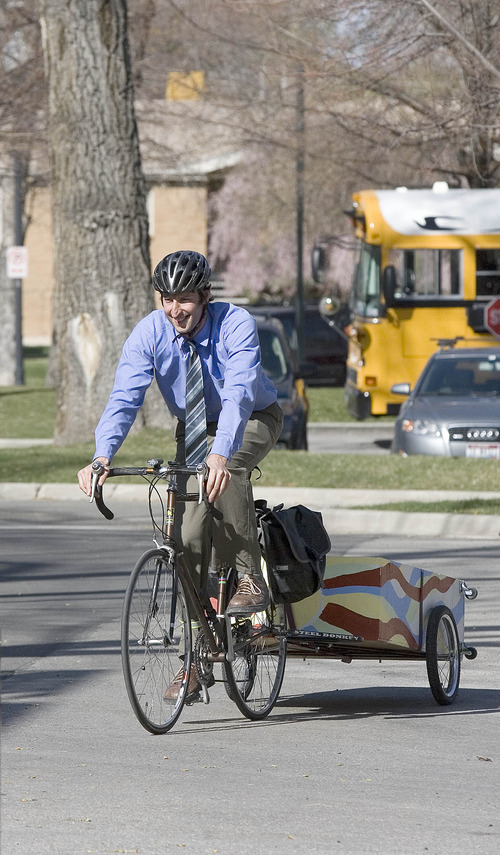 Paul Fraughton | The Salt Lake Tribune
Phil Sarnoff, of the Salt Lake Division of Sustainability, rides his bike in Liberty Park, towing a wagon that he uses to carry support materials to promote the City's SmartTrips program. The program held its kickoff event outside Tracy Aviary on Wednesday, March 28, 2012.