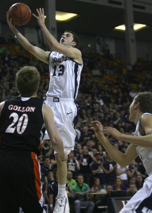 Kim Raff | The Salt Lake Tribune
Utah State University player Preston Medlin attempts a layup as Mercer player Jakob Gollon defends during the CIT Championship game at Utah State University in Logan, Utah on March 28, 2012.