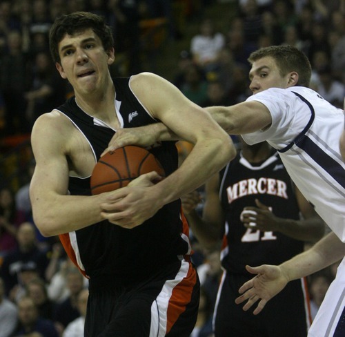 Kim Raff | The Salt Lake Tribune
Utah State University (right) Morgan Grim reaches for the ball as Mercer player Daniel Coursey protects the rebound during the CIT Championship game at Utah State University in Logan, Utah on March 28, 2012.  Mercer went on to win the game 67-70.