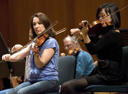 Paul Fraughton | The Salt Lake Tribune.
Amateur musician Becky Held sits next to Utah Symphony violinist Wen Flatt at the symphony's  first Pro Am concert where professional musicians and amateurs sit side by side playing music by  Beethoven.
 Thursday, March 29, 2012