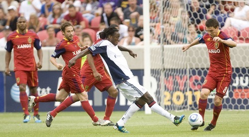 Jeremy Harmon  |  The Salt Lake Tribune

New England's Shalrie Joseph tries to keep the ball away from RSL defenders as Real Salt Lake hosts the Revolution Monday, July 4, 2011.