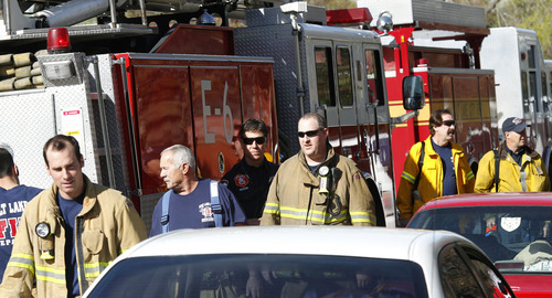 Al Hartmann  |  The Salt Lake Tribune
Salt Lake City firefighters stand down Thursday morning after a long night and morning at an apartment complex at 400 North and Redwood Road where a fire broke out in the early morning. About 140 renters removed clothes and valuables Thursday morning from their smoke-damaged apartment building.