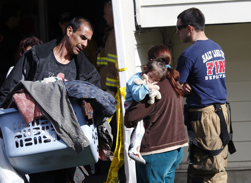 Al Hartmann  |  The Salt Lake Tribune
It was a long night and morning for renters at an apartment complex at 400 North and Redwood Road. Salt Lake City Fire Department and police allowed some of the 140 renters to remove clothes and valuables Thursday morning from their smoke-damaged apartment building.