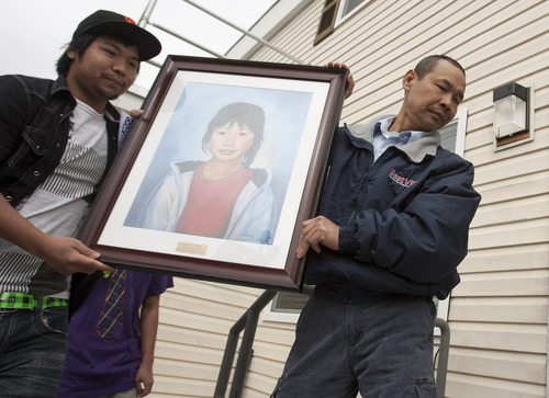 Leah Hogsten  |  The Salt Lake Tribune
Hser Ner Moo's father, Cartoon Wah, carries artwork with the likeness of his slain daughter Hser Ner Moo into the community center named after her. The Burmese community and parents of slain refugee Hser Ner Moo, who was allegedly murdered by another refugee in 2008, rededicated the Hser Ner Moo Community and Welcome Center on March 17 in South Salt Lake.