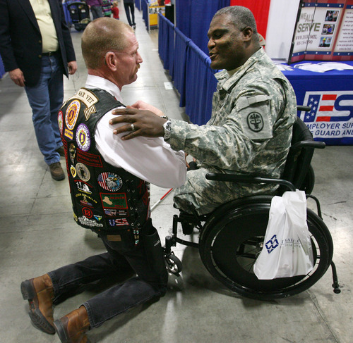 Steve Griffin  |  The Salt Lake Tribune
Iraq War veteran Gordon Ewell, left, of Eagle Mountain, shakes hands with Col. Gregory D. Gadson, who is with the U.S. Army Wounded Warrior Program, as they talk during the Utah Veterans and Families Summit at the Calvin L. Rampton Salt Palace Convention Center in Salt Lake City on Friday.