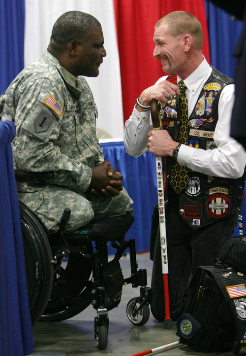 Steve Griffin  |  The Salt Lake Tribune
Iraq War veteran Gordon Ewell, right, of Eagle Mountain, Utah, talks with Col. Gregory D. Gadson, who is with the U.S. Army Wounded Warrior Program, as they talk during the Utah Veterans and Families Summit at the Calvin L. Rampton Salt Palace Convention Center in Salt Lake City on Friday.
