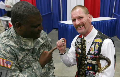 Steve Griffin  |  The Salt Lake Tribune
Iraq War veteran Gordon Ewell, right, of Eagle Mountain, Utah, laughs with Col. Gregory D. Gadson, who is with the U.S. Army Wounded Warrior Program, as he holds his glass eye as they talk during the Utah Veterans and Families Summit at the Salt Palace Convention Center in Salt Lake City on Friday. Ewell was severely injured after a vehicle he was driving was blown up by an improvised explosive device (IED) during he war.