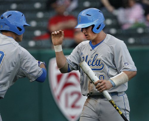 Scott Sommerdorf  |  The Salt Lake Tribune             
UCLA catcher Tyler Heineman gets congratulations from team mates as he comes back to the dugout after scoring on a squeeze play for  UCLA's first run in the top of the first. UCLA held a 1-0 lead after one inning. UCLA plays Utah in the Utes' Pac-12 baseball opener at Spring Mobile Ballpark, Friday, March 30, 2012.