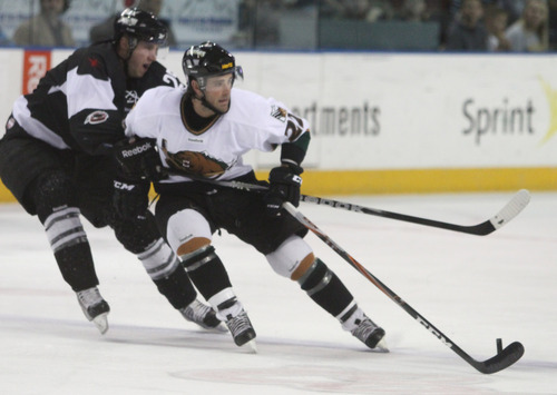 Rick Egan  | The Salt Lake Tribune 

C.J. Severyn controls the puck, as Channing Boe (25) defends for the Wranglers, in ECHL action Grizzlies vs. The Las Vegas Wrangles, at the Maverick Center,  Monday, April 2, 2012.