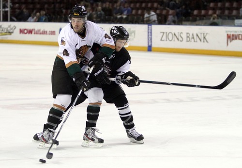 Rick Egan  | The Salt Lake Tribune 

The Grizzlies' David Strathman (4) battles Wrangler, Ash Goldie (15) for the puck, in ECHL action Grizzlies vs. The Las Vegas Wrangles, at the Maverick Center,  Monday, April 2, 2012.