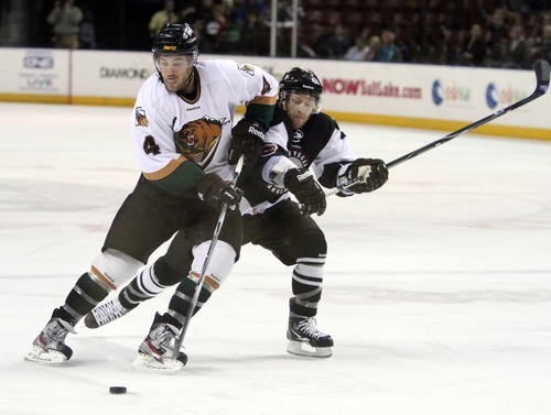 Rick Egan  | The Salt Lake Tribune 

The Grizzlies' David Strathman (4) battles Wrangler, Ash Goldie (15) for the puck, in ECHL action Grizzlies vs. The Las Vegas Wrangles, at the Maverick Center,  Monday, April 2, 2012.