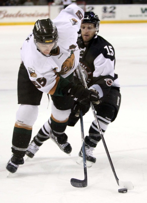 Rick Egan  | The Salt Lake Tribune 

The Grizzlies' Ryan Turek (55) battles Wrangler, Ash Goldie (15) for the puck, in ECHL action Grizzlies vs. The Las Vegas Wrangles, at the Maverick Center,  Monday, April 2, 2012.