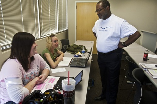 Chris Detrick | The Salt Lake Tribune 
Ron Stallworth teaches Amanda Clark and Brandee Wright in a criminal justice class at Eagle Gate College on Tuesday, April 19, 2011.
