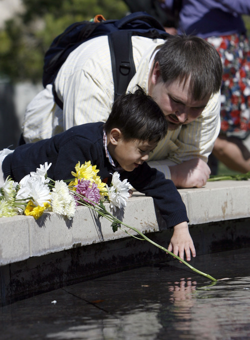 Francisco Kjolseth  |  The Salt Lake Tribune
Drawn by water Brian Hoopes of Taylorsville stays close his son Patrick, 3, who is tethered to him for his intravenous fluids since he was essentially born without intestines. On Wednesday, April 4, 2012, Patrick ceremoniously started the Celebration of Life Monument fountain on Library Square in Salt Lake which is dedicated to those who have given the gift of life through organ, eye, tissue and blood donation. Patrick has been on the donor list for a small intestine for three years.