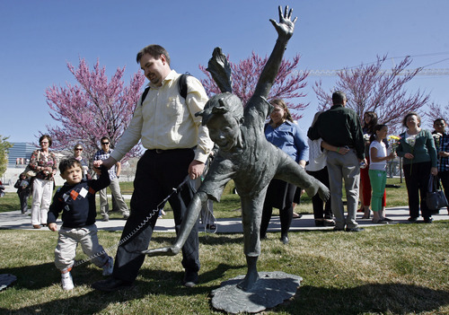 Francisco Kjolseth  |  The Salt Lake Tribune
Brian Hoopes of Taylorsville holds on to his son Patrick, 3, who needs to stay within a tethered distance for his intravenous fluids since he was essentially born without intestines. On Wednesday, April 4, 2012, Patrick ceremoniously started the Celebration of Life Monument fountain on Library Square in Salt Lake which is dedicated to those who have given the gift of life through organ, eye, tissue and blood donation. Patrick has been on the donor list for a small intestine for three years.