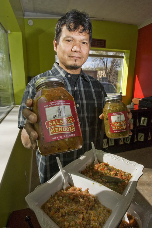 Paul Fraughton | The Salt Lake Tribune.
Sergio Mendoza holds bottles of gourmet salsas he makes and sells at Salsitas Mendoza.