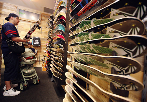 Lennie Mahler  |  The Salt Lake Tribune
Gennin Lewis browses the skateboard decks at Epic Boardshop inside the Gateway Mall in Salt Lake City, Wednesday, April 4, 2012. The shop recently opened in a location previously occupied by Gymboree, which is now located at City Creek Center.