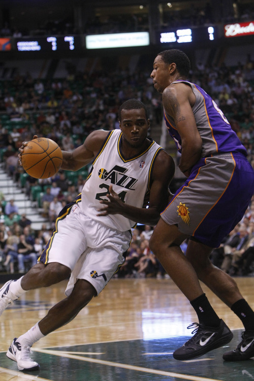 Chris Detrick  |  The Salt Lake Tribune
Utah Jazz power forward Paul Millsap (24) is guarded by Phoenix Suns center Channing Frye (8) during the first quarter of the game at EnergySolutions Arena Wednesday April 4, 2012. Utah is winning the game 24-21.