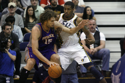 Chris Detrick  |  The Salt Lake Tribune
Utah Jazz forwardcenter Derrick Favors (15) guards Phoenix Suns center Robin Lopez (15) during the second quarter of the game at EnergySolutions Arena Wednesday April 4, 2012. At half time, Phoenix is winning the game 58-56.