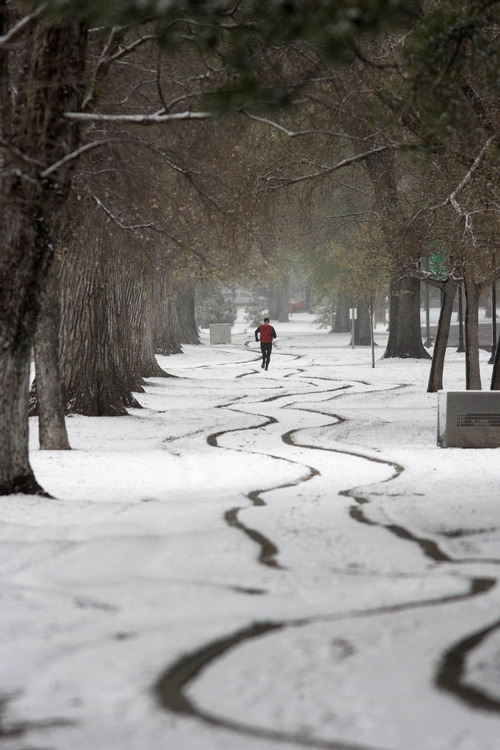 Paul Fraughton  |  The Salt Lake Tribune
Timothy Ricks follows the winding snow-covered path through Liberty Park on his morning run on Friday.