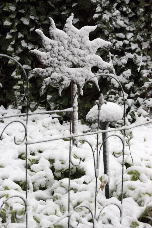 Paul Fraughton  |  The Salt Lake Tribune.
A sunburst garden decoration is coated in a layer of snow, a momentary pause in Springtime, as the weekend weather promises a return to warmer temperatures.