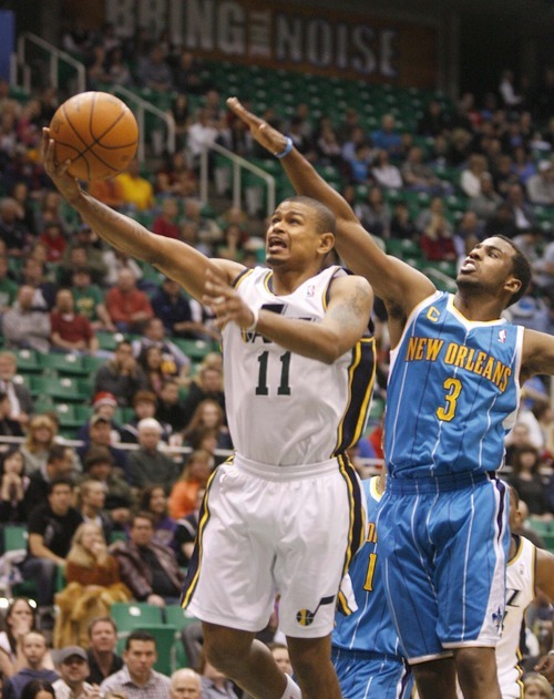 Paul Fraughton  |  The Salt Lake Tribune
Utah Jazz point guard Earl Watson (11) takes the shot as New Orleans Hornets point guard Chris Paul (3) defends .The Utah Jazz played the New Orleans Hornets at EnergySolutions Arena on Thursday  March 24, 201.1