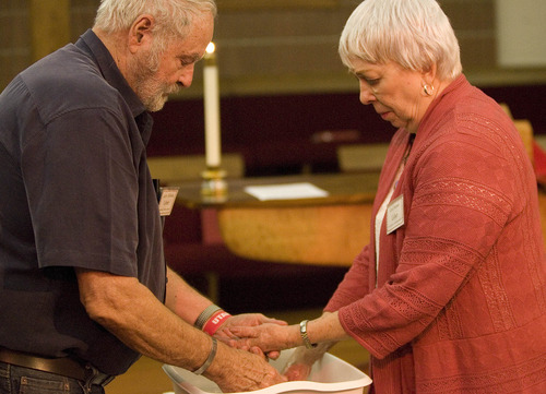 Paul Fraughton | The Salt Lake Tribune
Larry Holmes washes the hands of his wife, Carol, at  Our Saviour's Lutheran Church's Maundy Thursday observance April 5, 2012.