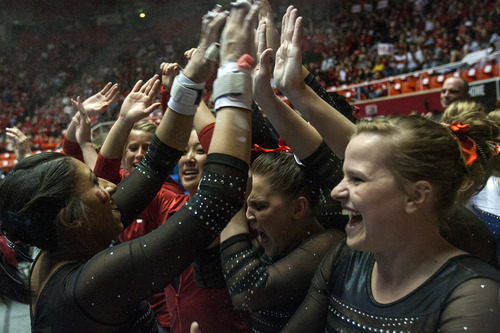 Chris Detrick  |  The Salt Lake Tribune
Utah's Kassandra Lopez celebrates with her teammates after competing on the bars on the floor exercise during the NCAA gymnastics Regionals at the Huntsman Center Saturday April 7, 2012. Lopez finished in 2nd place with a score of 9.8750. Utah won the meet with a score of 196.8250 and will compete in the national championship April 20-22 in Duluth, Georgia.