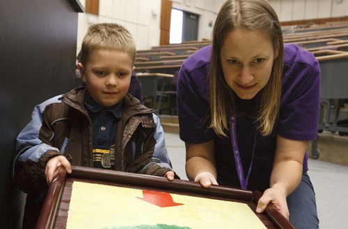 Leah Hogsten  |  The Salt Lake Tribune
Calvin Clark, 6, of Ogden, and Weber State University junior Cassie Grether learn about waves and what happens during an earthquake on Saturday at Weber State University's Lind Lecture Hall during earthquake preparedness event.