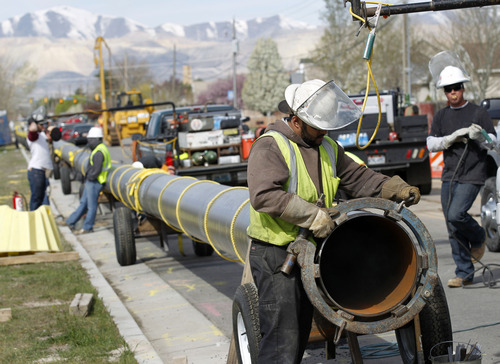 Al Hartmann  |  The Salt Lake Tribune 
Workers lay down pipe along 134000 South and 2400 West on Tuesday April 10.  Questar is replacing 8.5 miles of feeder line that runs along 13400 South in Riverton and Herriman.   The project is expected to be completed later this summer.