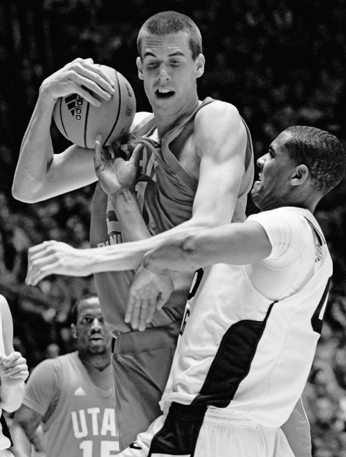 Chris Detrick  |  The Salt Lake Tribune 
Utah Utes center David Foster and Brigham Young Cougars forward Brandon Davies battle for the ball during the game at the Huntsman Center Jan. 11, 2011. BYU won the game 104-79.
