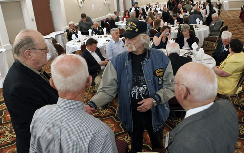 Al Hartmann  |  The Salt Lake Tribune
Vietnam POW Dave Groves shakes the hands of POWs from World War II during a prisoner of war appreciation luncheon Friday in Salt Lake City.