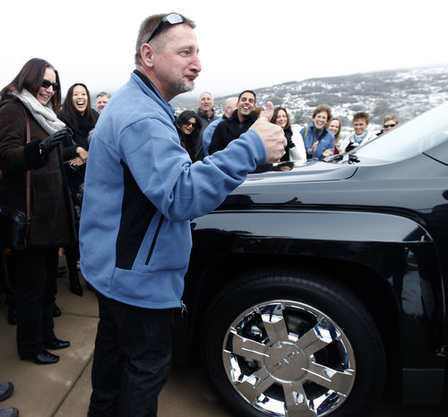 Al Hartmann  |  The Salt Lake Tribune
Winner William Naggy kicks the tire and gives a thumbs up to the new Chevrolet SUV he and his wife won -- in addtion to the new $2 million dollar grand prize HGTV Dream Home in Midway.