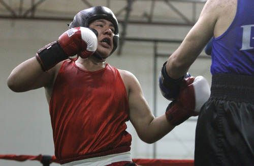 Rick Egan  | The Salt Lake Tribune 
Marco Alvarez, Ogden, (red), fights Hugo Hernandez, PAL (blue), in the154 lb division, in the Rocky Mountain Golden Gloves Regionals at the Sports Mall in Murray, Saturday, April 14, 2012.