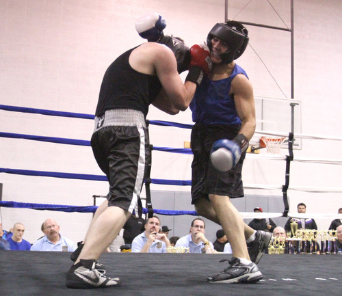 Rick Egan  | The Salt Lake Tribune 

Cameron West, FFYL, (black) fights Miguel Garcia (Fullmers Boxing (blue), in the178 lb jr olympic & novice class division, in the Rocky Mountain Golden Gloves Regionals at the Sports Mall in Murray, Saturday, April 14, 2012.