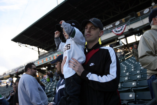 Kim Raff | The Salt Lake Tribune
Mark Bevans holds his son Jackson Bevans at the Bees homeopener against Tucson Padres at Spring Mobile Ballpark in Salt Lake City, Utah on April 13, 2012.