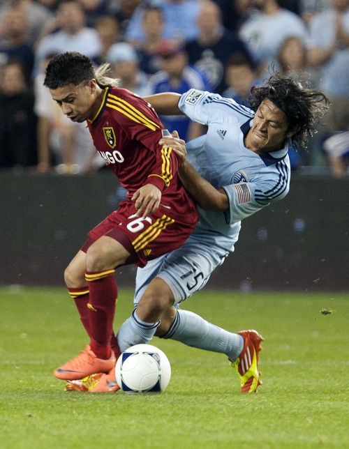 Real Salt Lake's Sebastion Velasquez fights for the ball with Sporting Kansas City's Roger Espinoza during an MLS soccer match, Saturday, April 14, 2012, in Kansas City, Kan. Sporting Kansas City won 1-0. (AP Photo/The Kansas City Star, Andy Lundberg)