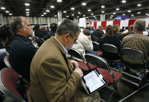 Scott Sommerdorf  |  The Salt Lake Tribune             
GOP delegate Ron Bird works on his computer during speeches at the GOP convention, Saturday, April 14, 2012. Salt Lake County Republicans gathered to select candidates for county posts.