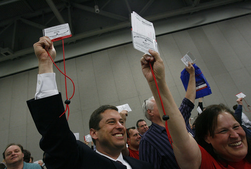 Scott Sommerdorf  |  The Salt Lake Tribune             
Sen. Aaron Osmond, R-Salt Lake, along with other delegates, raises his credential to vote on an item on the agenda during the GOP convention, Saturday, April 14, 2012. Salt Lake County Republicans gathered to select candidates for county posts.